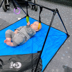 baby on play mat on airport floor