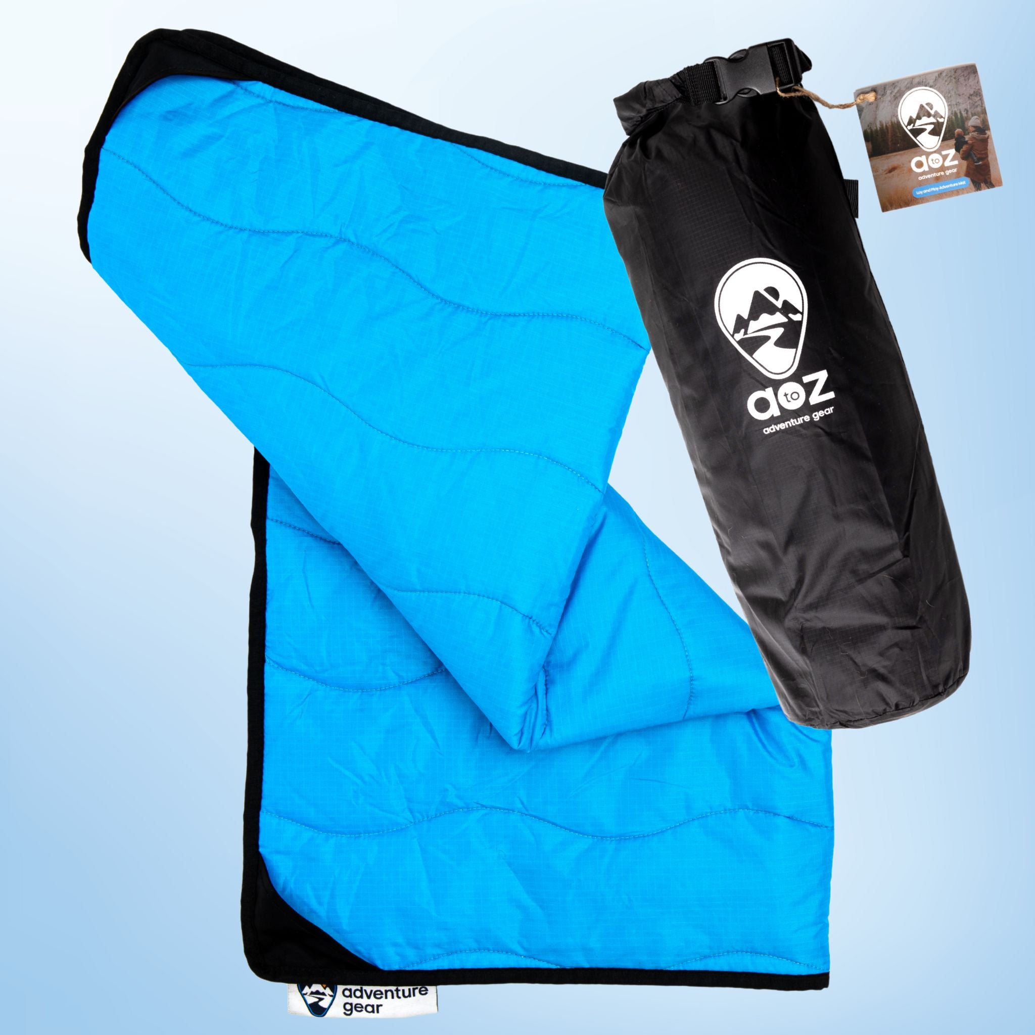 Blue quilted outdoor mat and black carrying stuff sack with a brand logo on a light blue background